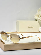 C DE RIMLESS ROUND FRAME SUNGLASSES CT0611S IN METAL